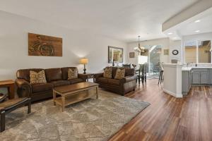 a living room with two couches and a kitchen at Old Mill Magic in Bend +30 photos