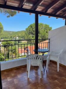 a balcony with a table and chairs and a view at Villa Elpiniki in Troulos