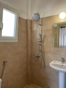 a bathroom with a shower and a sink at Villa Elpiniki in Troulos