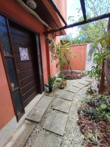 a front door of a house with a walkway at Suíte Privativa in Paraty +26 photos