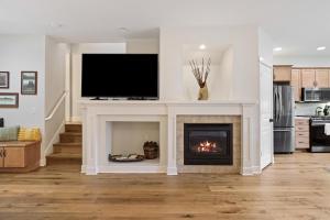 a living room with a fireplace with a flat screen tv at Tranquility on the Bluffs in Bend