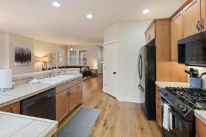 a kitchen with a sink and a stove at Tranquility on the Bluffs in Bend