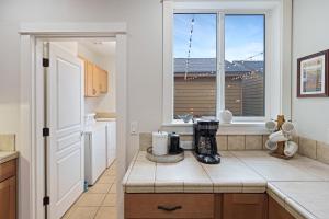 a kitchen with a blender on a counter with a window at Tranquility on the Bluffs in Bend +29 photos