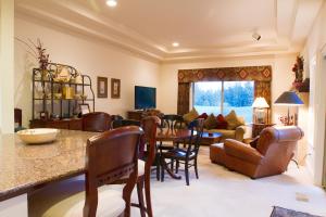a living room with a table and chairs and a couch at Villa #5 at Broken Top in Bend