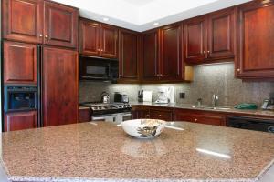 a kitchen with wooden cabinets and a bowl on a counter at Villa #5 at Broken Top in Bend
