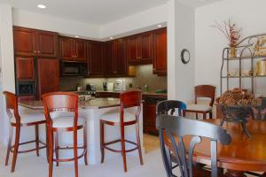 a kitchen with wooden cabinets and a table and chairs at Villa #5 at Broken Top in Bend