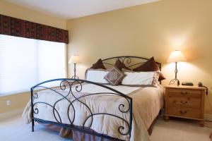 a bedroom with a bed and a window at Villa #5 at Broken Top in Bend