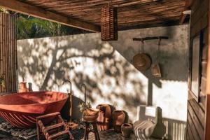 a bathroom with a red bath tub and a shadow of a tree at Baba Yaga Atitlan in San Marcos La Laguna