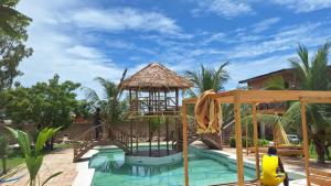 a resort pool with a bridge and a gazebo at Résidence Tina 1 in Ngalou Sessène +43 photos