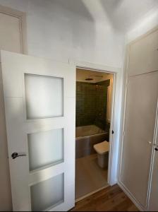 a bathroom with a white door and a toilet at Casa Limón in Palma de Mallorca +23 photos