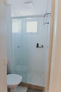 a bathroom with a glass shower with a toilet at Apto moderno c/ Vista Incrível para o Mar in Itaparica