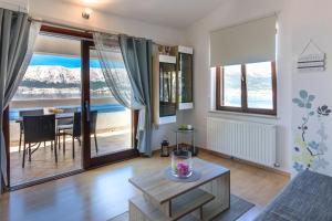 a living room with a couch and a table at Apartments with a parking space Baska, Krk - 23918 in Baška