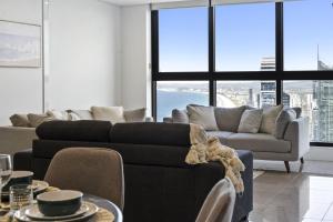 a living room with a couch and a table at Oceans Suites - Q Stay in Gold Coast