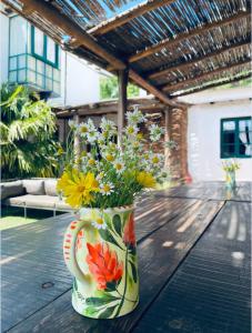a vase filled with flowers sitting on a wooden table at Estancia San Pablo in Tupungato +10 photos