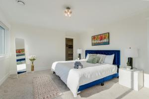a white bedroom with a blue and white bed at Elegant Home In Victoria,BC in Langford
