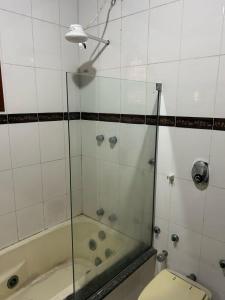 a bathroom with a shower and a tub and a toilet at Rico Hostel in Cabo Frio +28 photos