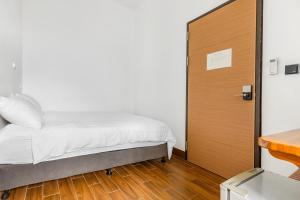 Postel nebo postele na pokoji v ubytování 25Inn Hengchun Kenting