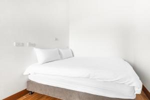 Postel nebo postele na pokoji v ubytování 25Inn Hengchun Kenting