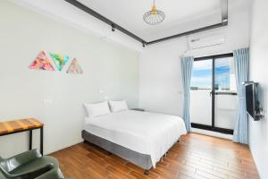 Postel nebo postele na pokoji v ubytování 25Inn Hengchun Kenting