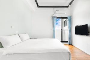 Postel nebo postele na pokoji v ubytování 25Inn Hengchun Kenting