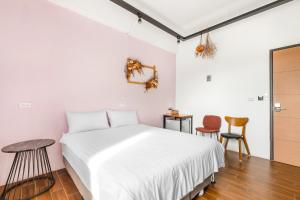 Postel nebo postele na pokoji v ubytování 25Inn Hengchun Kenting