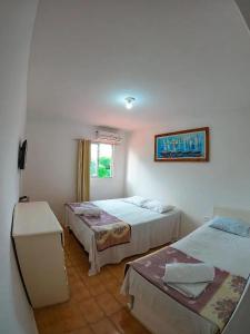 Ένα ή περισσότερα κρεβάτια σε δωμάτιο στο Suites Porto Dos Milagres