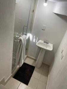 un bagno bianco con lavandino e doccia di Departamento Mazatlan a Mazatlán Altre 7 foto