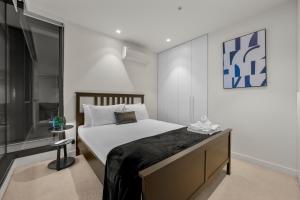 a bedroom with a large bed and a television at Unwind with Beautiful Park & Bay Views in Melbourne +19 photos
