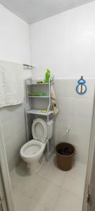 a bathroom with a white toilet in a room at John and Novy Camotes Beach Bungalows in San Francisco