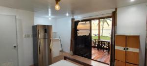 a kitchen with a refrigerator and a view of the ocean at John and Novy Camotes Beach Bungalows in San Francisco