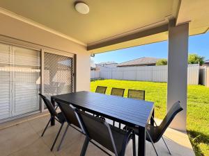 a black table and chairs on a patio at Blue Haven Retreat - Jordan Springs in Kingswood