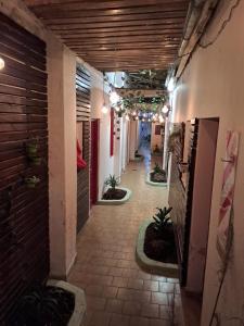 a hallway of a building with plants and lights at Parque Chacabuco in Mar del Plata