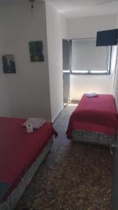 a room with two beds and a window in it at Parque Chacabuco in Mar del Plata