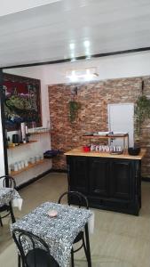 a room with a table and chairs and a brick wall at Parque Chacabuco in Mar del Plata
