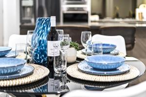 a table with blue plates and a bottle of wine at Oceans Suites - Q Stay in Gold Coast