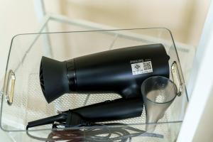 een zwarte föhn in een glazen kast bij Full house 2BR near Bus station North Pattaya in Pattaya