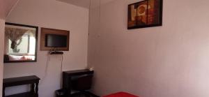 a corner of a room with a tv on the wall at Hotel Posada San Luis in Tepic