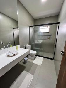 a bathroom with a sink and a toilet and a shower at Solar da madame in Morro de São Paulo