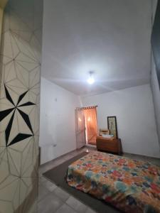 a bedroom with a bed and a chair in it at Casa amplia in Villa Constitución