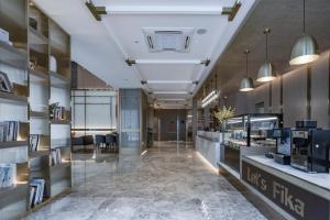a lobby of a store with a reception desk at Lijiang Old Town Echarm Plus Hotel in Lijiang