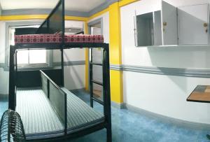 a room with a spiral staircase in a house at RGL Pinamalayan Condotel by RedDoorz in Pinamalayan