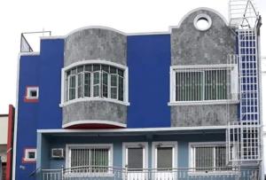 a large blue building with a large window at RGL Pinamalayan Condotel by RedDoorz in Pinamalayan
