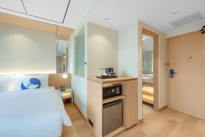 a hotel room with a bed and a kitchen at FOX Lite Hotel Majalaya in Bojong