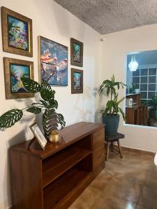 a room with a wooden cabinet and a potted plant at Casa Estrella de mar in Tela