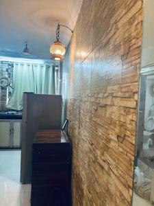 ein Zimmer mit einer Ziegelwand mit einem Tisch darin in der Unterkunft Den near the sea in Mumbai + 3 Fotos