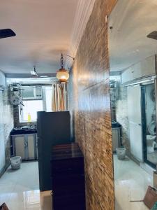 ein Badezimmer mit 2 WCs und einer Ziegelwand in der Unterkunft Den near the sea in Mumbai