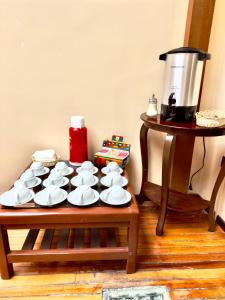 a table with a bunch of cups and plates on it at Travel Hotel Quito in Quito