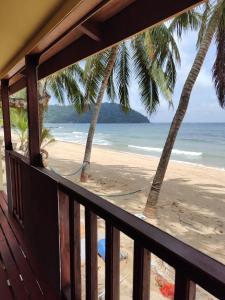 a balcony with a view of the beach at Permata Beach Chalet in Kampong Juara