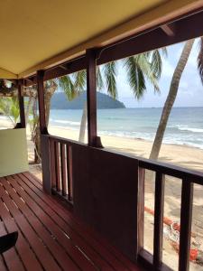 a balcony with a view of the beach at Permata Beach Chalet in Kampong Juara