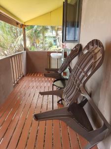 two chairs and a table on a balcony at Permata Beach Chalet in Kampong Juara